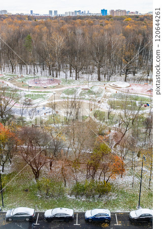 parked cars and playground covered by first snow 120644261
