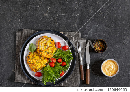 pumpkin carrot potato patties on plate, top view pumpkin carrot potato patties on plate, top view 120644663