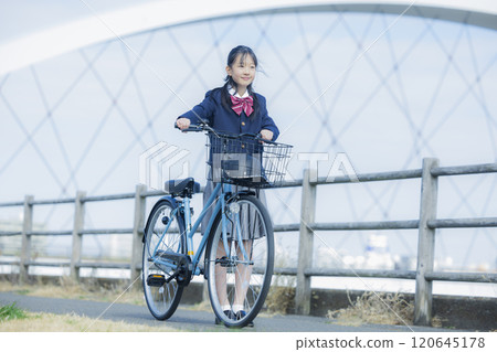 High school girl riding a bicycle on the riverbed 120645178