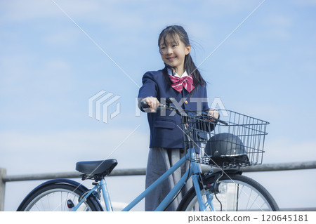 High school girl riding a bicycle on the riverbed 120645181