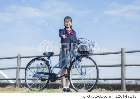 High school girl riding a bicycle on the riverbed 120645182