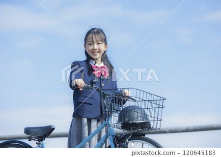 High school girl riding a bicycle on the riverbed 120645183
