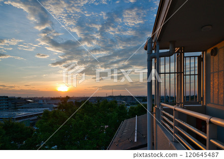 Clouds illuminated by the morning sun. Morning glow spreading over a residential area. Sunrise. Morning in a residential area. Early morning. Morning glow. Morning sun. Sun. Clouds illuminated by the morning sun. Morning glow spreading over a residential area. Sunrise. Morning in a residential area. Early morning. Morning glow. Morning sun. Sun. 120645487