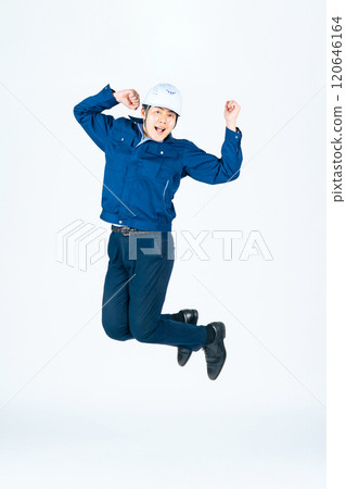 Full-body photo of a male worker jumping 120646164