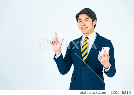 Full-body photo of a young male business person holding a smartphone and giving directions Full-body photo of a young male business person holding a smartphone and giving directions 120646210