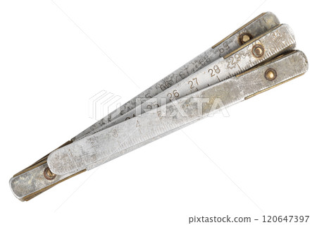 Antique carpenter's brass ruler isolated on white. Antique carpenter's brass ruler isolated on white. 120647397