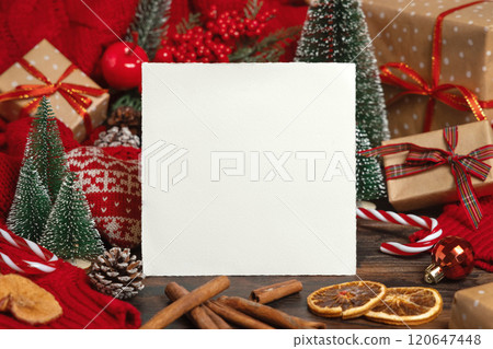 Greeting card near Christmas decor, trees, spices and red knitted sweater, winter mockup 120647448