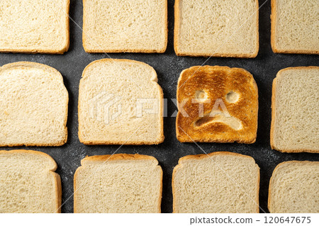 Gluten food, celiac disease, slice of toasted bread with sad face. Gluten sensitivty 120647675