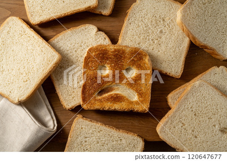 Gluten food, slice of toasted bread with sad face. Gluten allergy concept Gluten food, slice of toasted bread with sad face. Gluten allergy concept 120647677