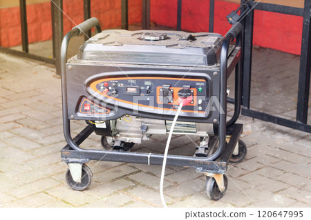 Portable gasoline or diesel generator to provide electricity. Problem with electricity. Blackout. Sunny. Portable gasoline or diesel generator to provide electricity. Problem with electricity. Blackout. Sunny. 120647995