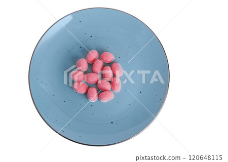 Pink jelly candies on a blue plate isolate on a white background. 120648115
