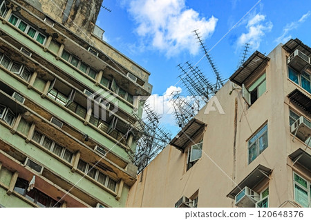 Dense urban architecture in Hong Kong with tightly packed high-rise buildings under a bright sky Dense urban architecture in Hong Kong with tightly packed high-rise buildings under a bright sky 120648376