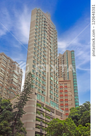 Dense urban architecture in Hong Kong with tightly packed high-rise buildings under a bright sky Dense urban architecture in Hong Kong with tightly packed high-rise buildings under a bright sky 120648381