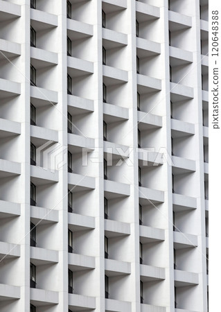 Modern high-rise facade with repeating geometric balconies creating a minimal and abstract urban pattern Modern high-rise facade with repeating geometric balconies creating a minimal and abstract urban pattern 120648388