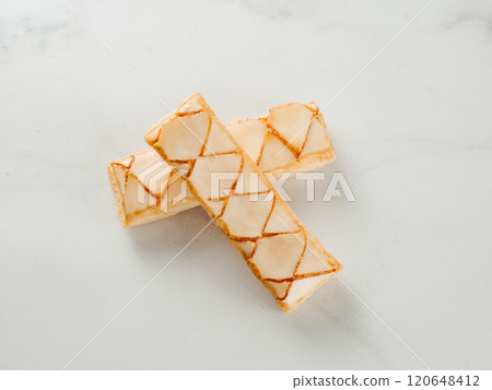 Italian crispy sweet bakery Sfogliatine glassate over white marble table surface. Tasty breakfast with apricot glaze puff pastries. 120648412