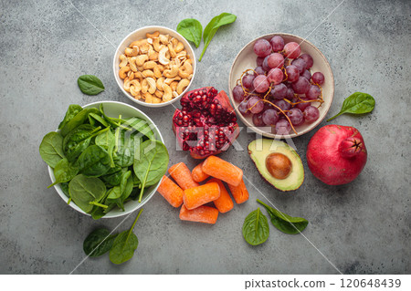 Healthy food containing potassium vitamin including cashews, grapes, avocado, pomegranate, baby carrot and spinach Healthy food containing potassium vitamin including cashews, grapes, avocado, pomegranate, baby carrot and spinach 120648439