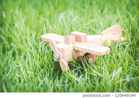 Wooden Toy Airplane on Grass Inspiring Imagination and Adventure Wooden Toy Airplane on Grass Inspiring Imagination and Adventure 120649194