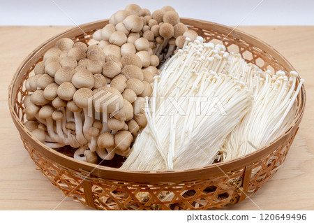 Assortment of mushrooms in a colander: Shimeji and Enoki mushrooms 120649496