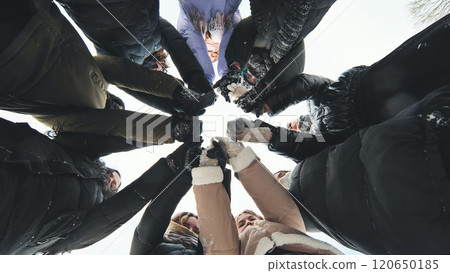 Schoolgirls joining hands in a winter circle for a snowy photoshoot Schoolgirls joining hands in a winter circle for a snowy photoshoot 120650185