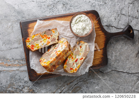 Spicy terrine pie with chicken liver, carrots, peppers, herbs and eggs close-up on a wooden board. Horizontal top view 120650228