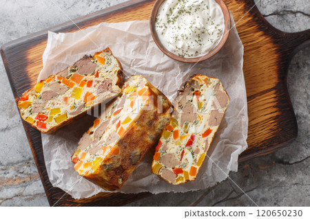 Liver casserole with vegetables, herbs and eggs close-up on a wooden board. Horizontal top view Liver casserole with vegetables, herbs and eggs close-up on a wooden board. Horizontal top view 120650230