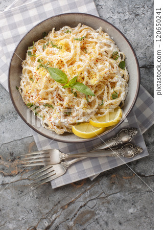 Linguine pasta with lemon zest and ricotta cheese, parmesan close-up in a bowl. Vertical top view Linguine pasta with lemon zest and ricotta cheese, parmesan close-up in a bowl. Vertical top view 120650241