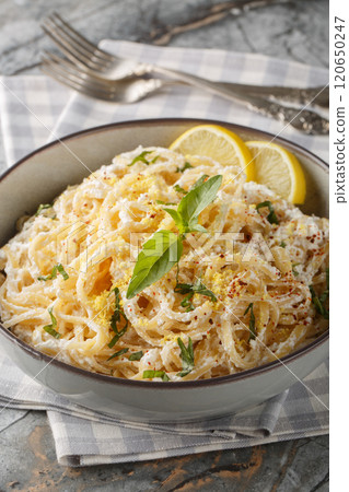 Linguine pasta with lemon zest and ricotta cheese, parmesan close-up in a bowl. Vertical 120650247