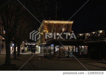 Nighttime Street in Sundsvall, Sweden, with Lit Cafes and Historic Architecture 120650319