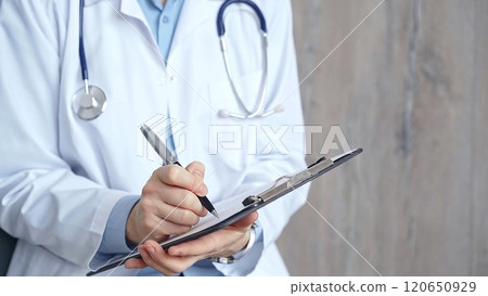 Healthcare professional doctor writing medical records on a clipboard. Female unrecognizable physician at work. Medicine and pharmacy 120650929