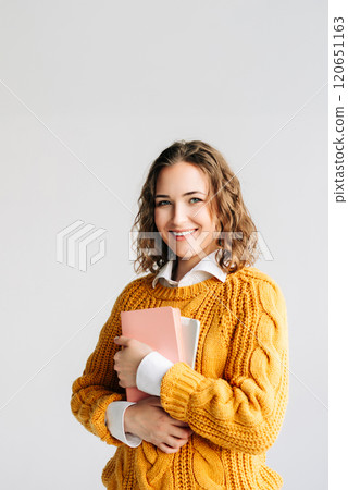 Cheerful Student with Digital Tablet. Smiling young woman holding a digital tablet, Ideal for themes Cheerful Student with Digital Tablet. Smiling young woman holding a digital tablet, Ideal for themes 120651163