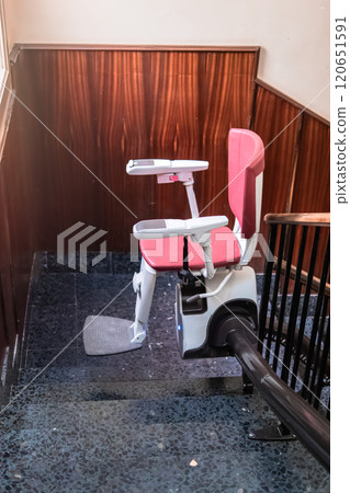 Empty Stairlift on Indoor Staircase for Accessibility Empty Stairlift on Indoor Staircase for Accessibility 120651591