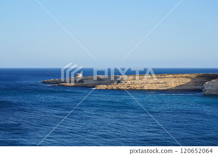 Expansive coastal cliff stretching into calm blue Mediterranean sea, serene landscape under clear sunny sky Expansive coastal cliff stretching into calm blue Mediterranean sea, serene landscape under clear sunny sky 120652064