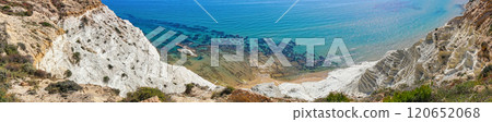 Aerial perspective of white cliffs and clear turquoise water with visible underwater rocks along Mediterranean coastline in Scala dei Turchi Aerial perspective of white cliffs and clear turquoise water with visible underwater rocks along Mediterranean coastline in Scala dei Turchi 120652068
