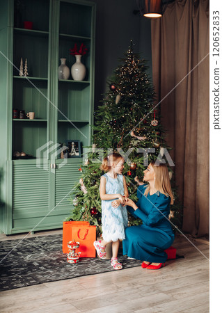 Little girl and her mom on Christmas morning at Little girl and her mom on Christmas morning at 120652833