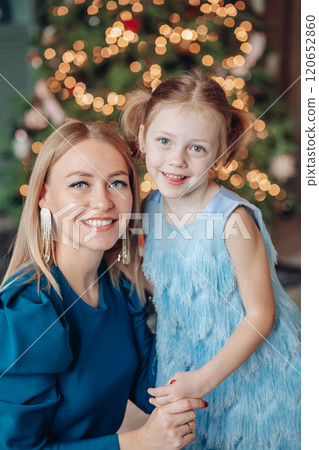 Little girl and her mom on Christmas morning at 120652860