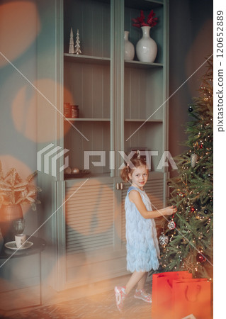 Cute smiling six-year-old girl with Xmas gift 120652889
