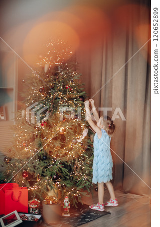 Cute smiling six-year-old girl with Xmas gift 120652899