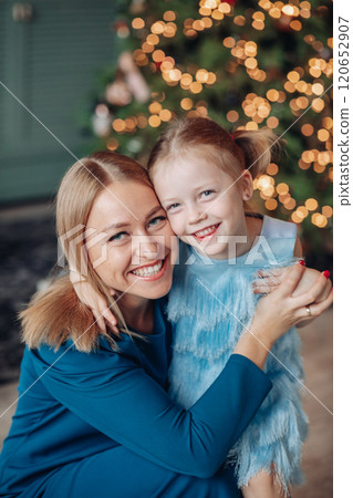 Little girl and her mom on Christmas morning at 120652907