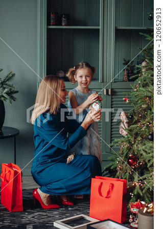 Little girl and her mom on Christmas morning at Little girl and her mom on Christmas morning at 120652913