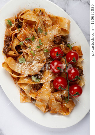 pappardelle pasta with bolognese sauce, topped with parmesan cheese and cherry branch, homemade, no people, 120653089