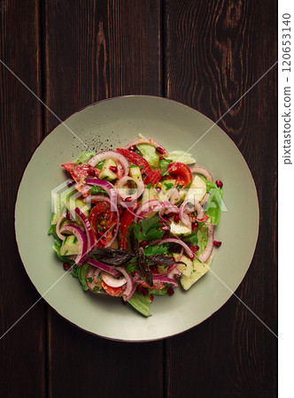 Georgian vegetable salad, tomatoes with cucumbers, red onion, walnut, pomegranate seeds, top view, no people, 120653140