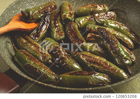 fried padron pepper, in a frying pan, with olive oil, and sea salt, homemade, no people. fried padron pepper, in a frying pan, with olive oil, and sea salt, homemade, no people. 120653208