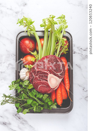 knuckle on the bone, raw meat for ossobuco, with vegetables, in a basket , ingredients for cooking ossobuco, top view, no people, knuckle on the bone, raw meat for ossobuco, with vegetables, in a basket , ingredients for cooking ossobuco, top view, no people, 120653240
