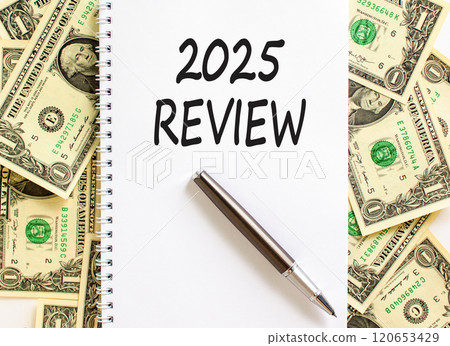 Planning 2025 review new year symbol. Concept words 2025 Review on beautiful white note. Beautiful background from dollar bills. Black pen. Business 2025 review new year concept. Copy space. 120653429