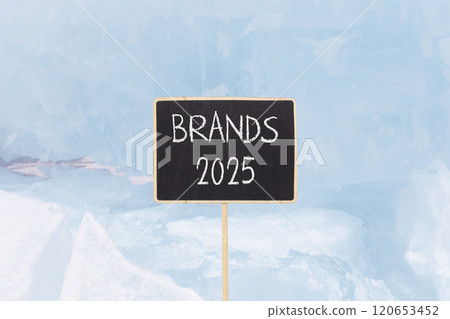 Planning brands 2025 new year symbol. Concept words Brands 2025 on beautiful yellow chalk blackboard. Beautiful blue Baikal lake ice background. Business brands 2025 new year concept. Copy space. 120653452