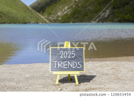Planning 2025 trends new year symbol. Concept words 2025 Trends on beautiful yellow chalk blackboard. Beautiful mountain lake sand beach background. Business 2025 trends new year concept. Copy space. 120653459