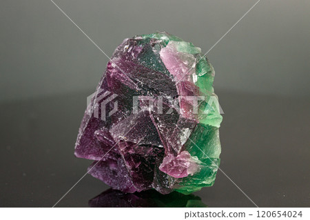 macro mineral stone green and purple fluorite on a black background 120654024