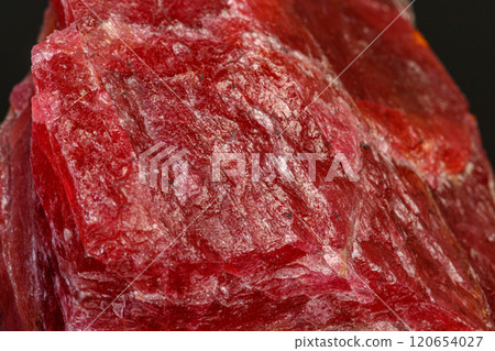 macro mineral Rhodonite stone on a black background 120654027