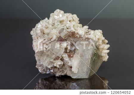 macro mineral stone Apophyllite stilbite on a gray background macro mineral stone Apophyllite stilbite on a gray background 120654052