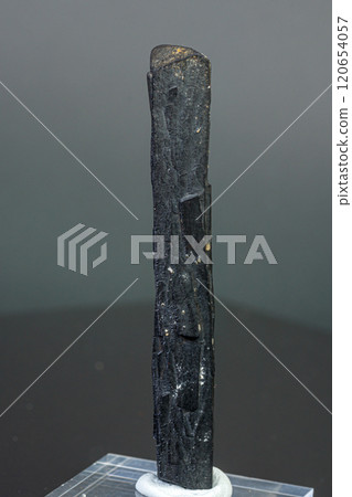 macro mineral stone Ilvaite on a gray background 120654057